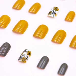 Short round vintage floral press-on nails in mustard yellow and grey tones