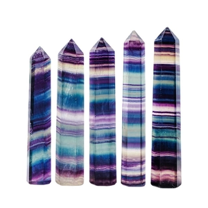 Five natural rainbow fluorite hexagonal crystal pillars standing on white background