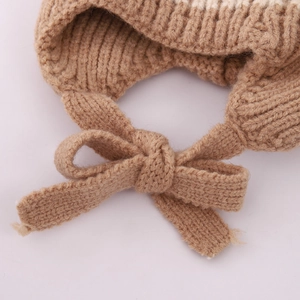 Detailed macro view of the brown knitted bow on a thick winter hat for children