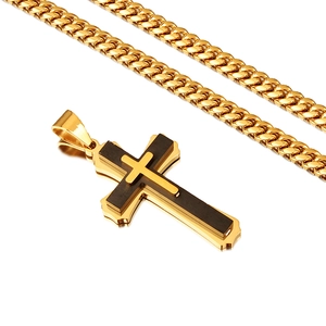 Detail of gold Cuban chain necklace with a black wood inlaid cross pendant for men