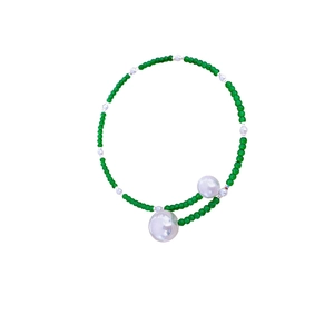Elegant green beaded necklace with large white baroque pearls in a minimalist chic style