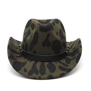 Detail of western cowboy hat in olive green felt with black cow print and studded leather band