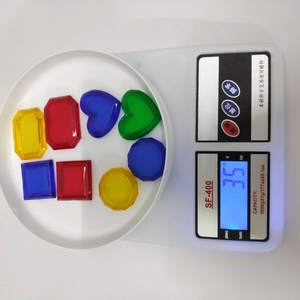 Weight measurement of 8 colorful plastic diving gems on a digital scale for pool toys