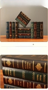 Detail of vintage European decorative book boxes with gold embossed spine patterns