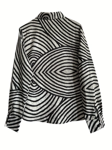 Detail view of the back of women's button-up shirt with black abstract geometric prints