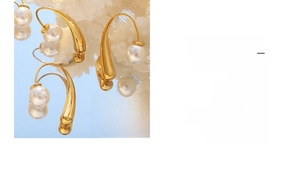 Detail of elegant gold drop earrings with pearls shown in a vintage mirror reflection