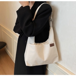 White canvas tote bag featuring a brown leather patch with FASHION logo on a nylon fabric