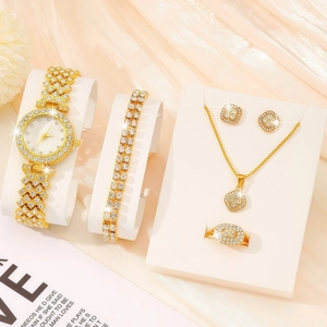 Close-up of luxury gold quartz watch set with crystal-encrusted bracelet and jewelry