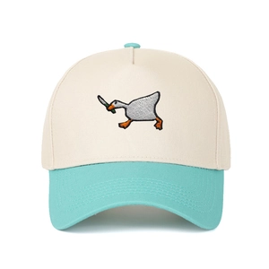 Detail of embroidered goose with knife meme on cream and blue cotton baseball cap