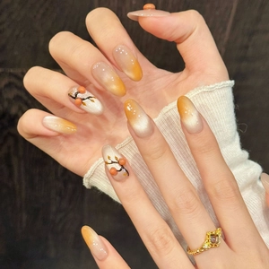 Handmade orange and cream cat-eye press-on nails with 3D berry accents and long oval shape
