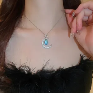 Star and moon zircon necklace with blue water drop pendant on female model