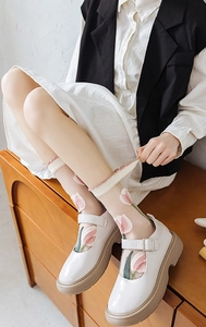 Détail de chaussettes en tulle transparent avec broderie tulipe et dentelle ondulée