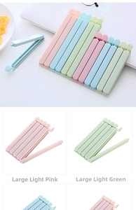 Detail of large macaron-colored food sealing clips in pink and green for snack storage