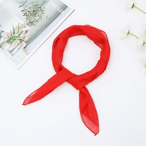 Detailed view of lightweight red chiffon square scarf with floral print and soft texture