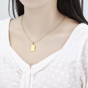 Minimalist gold plated padlock pendant necklace with bead chain on model