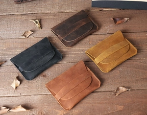 Flat lay of vintage crazy horse leather card holders in four distinct retro colors