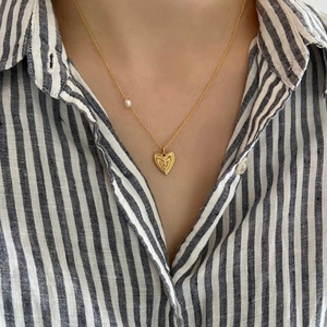 S925 sterling silver gold heart pendant necklace with pearl detail on a striped shirt
