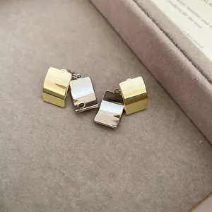 Minimalist square metal earrings with polished gold and silver layered geometric design