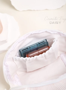 Interior view of daisy cosmetic bag showing elastic pockets and makeup storage detail