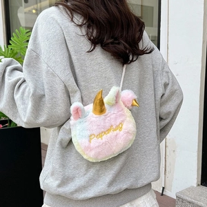 Colorful unicorn plush crossbody bag with gold horn and gradient fur shown on model back