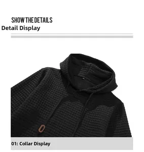 Detail view of black waffle texture hoodie showing drawstring with brown toggle and neckline