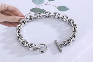 Detailed view of polished stainless steel chain link bracelet with OT toggle clasp design