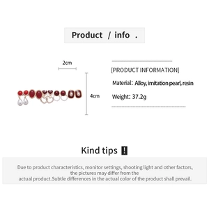Detail view of red resin heart earrings with faux pearls and alloy specifications