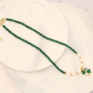 Detail of clover necklace with malachite beads, white pearls and evil eye charm