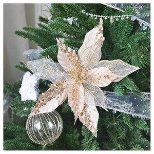 Close-up of champagne gold glitter SwanLace flower hanging on a Christmas tree branch