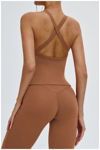 Detail of cross-back strap design on caramel brown yoga vest and leggings set