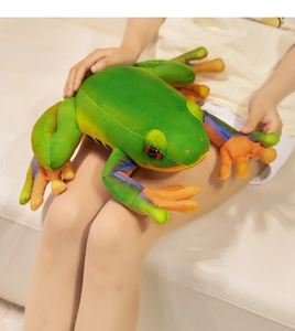 Detail of red-eyed tree frog plush toy showing vibrant green texture and orange feet