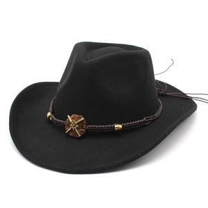 Detail of black wool felt cowboy hat with braided brown band and golden metallic buckle