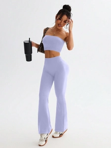 Close-up of ribbed texture on lavender seamless high waist yoga flare pants and crop top