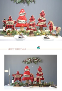 Close-up of fabric Christmas trees and stars with Merry Christmas prints on a table