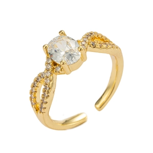 Detail of gold bow ring with oval clear zircon and sparkling pavé accents