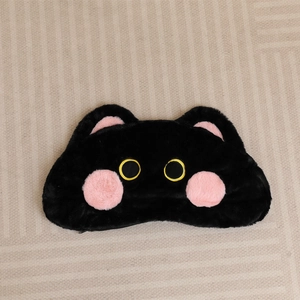 Detail of cute black cat plush pencil case featuring pink cheeks and yellow eyes
