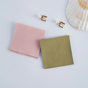 Pink and olive green velvet jewelry pouches with pearls and seashell decor details