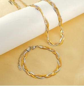 Detailed view of triple-layered woven stainless steel snake chain bracelet and necklace
