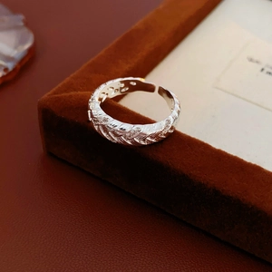 Detailed view of silver twist texture open ring with shimmering zircon on velvet tray