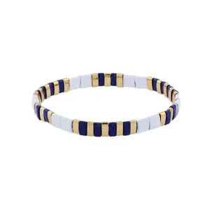 Detail of bohemian stretch bead bracelet with blue marble tiles and gold metallic accents
