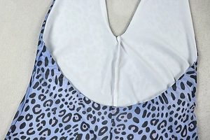 Close-up of purple leopard print bodysuit with white lining and neck seam details
