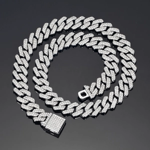 Macro shot of 14mm silver rhombic Cuban link chain with sparkling cubic zirconia stones