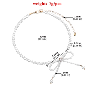 Faux pearl tassel necklace with sparkling bow pendant and detailed size measurements
