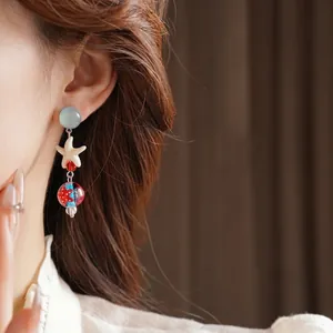 Starfish drop earrings with blue glass beads for an elegant ocean holiday style