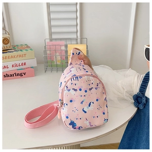 Detail of pink unicorn crossbody bag with adjustable strap on child model
