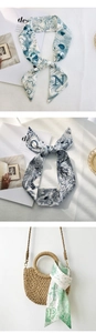 Close-up of printed silk twilly scarves used as artistic hair ties or bag handle decorations