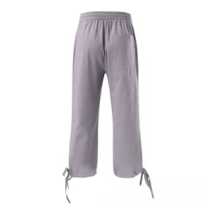 Detail view of cotton linen pants featuring drawstring cuffs and a back pocket design