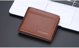 Detail of a brown leather wallet with embossed patterns and logo on a desk