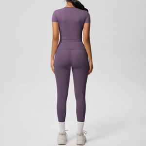Back view of a purple two-piece yoga set showing slim fit short sleeve top and leggings