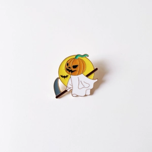 Detailed enamel pin featuring a pumpkin ghost with a scythe under a yellow moon